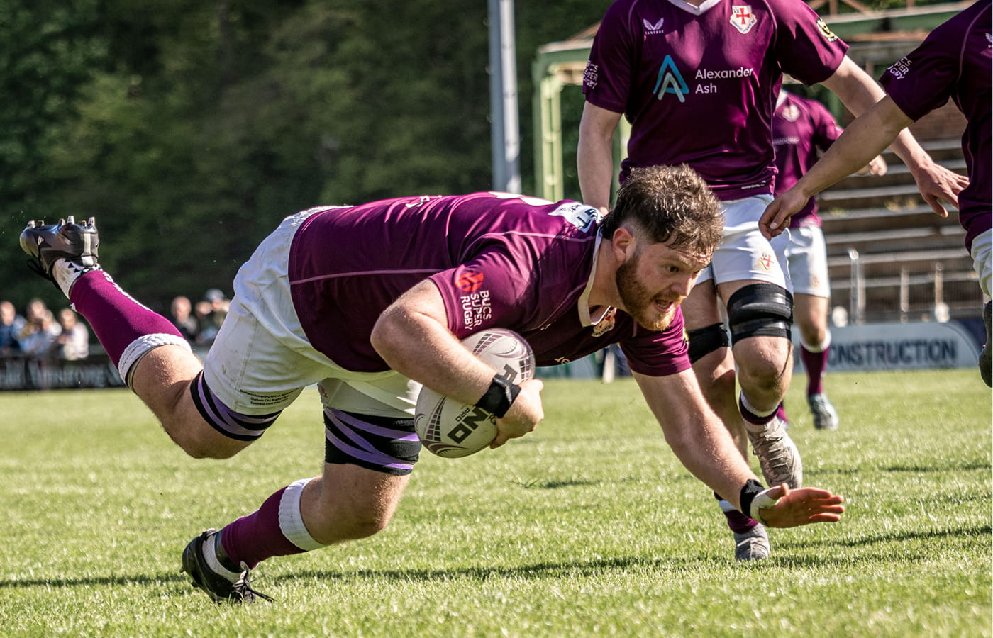 Marcus Rhodes scores a try during the DURFC 150 anniversary match against the Barbarians.